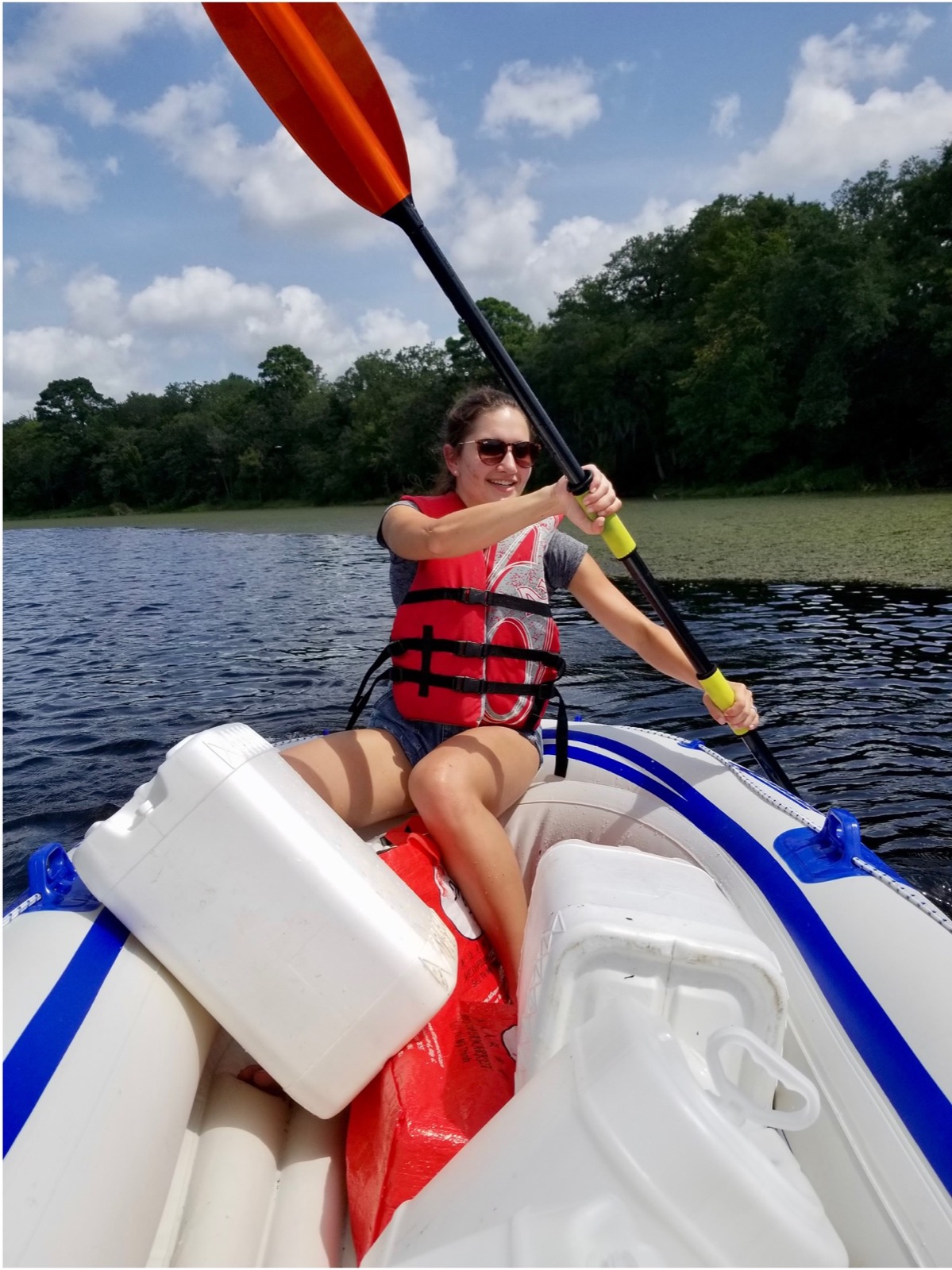 Victoria Todd paddling a fieldwork boat on a lake